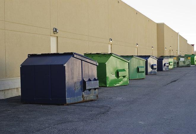 a row of blue construction dumpsters on a job site in Antlers, OK